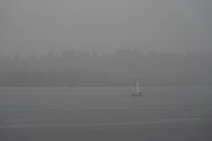 A sailboat cruise is through the Columbia River, despite the fog and torrential rain.