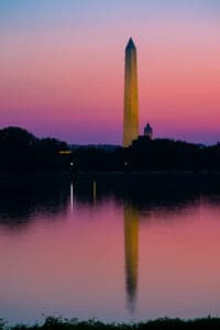 The Washington Monument reflecting in a pond surrounding Washington DC.
